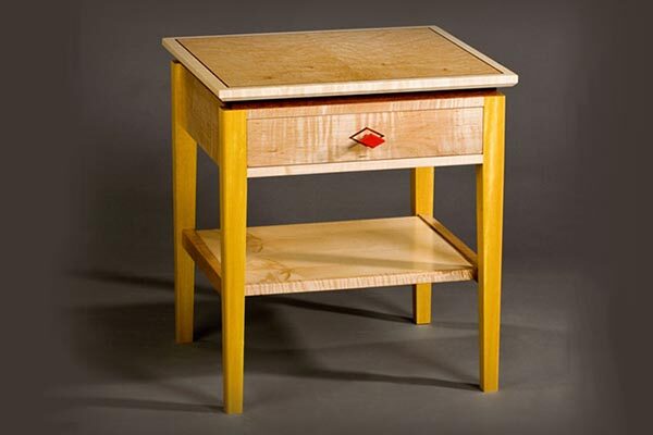 Deco style bedside table with drawer: Curly maple, birdseye maple, pau amarolo, red paint, bubinga inlay. 20″ w x 18″ d x 22″ h