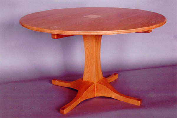 Solid cherry table; It’s got legs! Curly maple and bubinga inlays 52″ diameter 30″ h .
