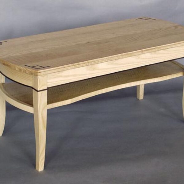 Curly ash coffee table: Ebony inlay, bent laminated white ash, black walnut detail. 42″ l x 17 1/2″ w x 18 1/2″ h