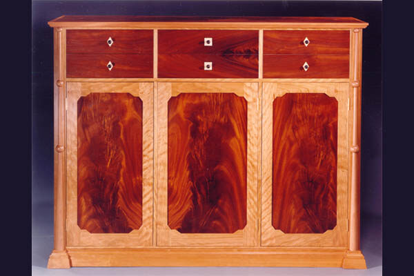 Dresser: Curly cherry, crotch magogany, pearwood columns with inlaid drawer details of maple and ebony. 52 ” l x 50″ h x 20″ d
