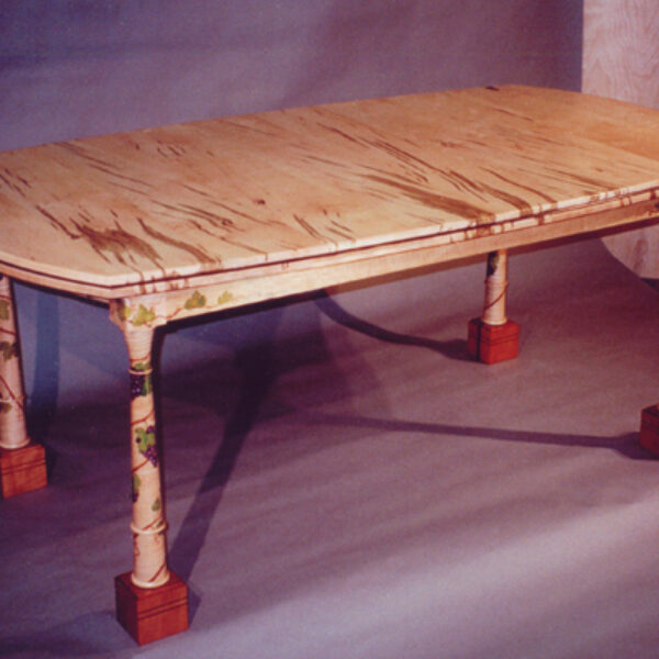 Dining table: This lovely table seats six to ten people. Made of worm hole maple, curly maple, pearwood feet with hand-painted grape vines.