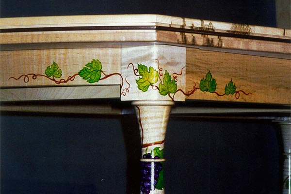 Detail of dining table with painted leaves